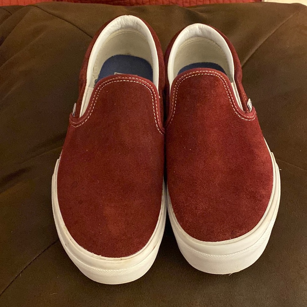 Burgundy platform slip on Vans sneakers.